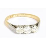 An 18ct yellow gold platinum tipped three stone diamond ring, the central stone weighing approx 0.