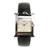 HERMÈS; a stainless steel wristwatch, the rounded square dial set with Arabic numerals within the