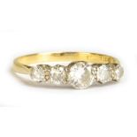 A yellow metal five stone diamond ring, the central diamond weighing 0.50cts, size Q 1/2, approx 2.