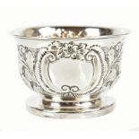 WILLIAM DEVONPORT; an Edwardian hallmarked silver embossed bowl raised on stepped circular foot,