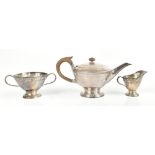 LIBERTY & CO; a George V hallmarked silver three piece tea service, each with planished and embossed