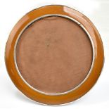 JOSEPH GLOSTER LTD; a George V hallmarked silver and simulated enamel circular photograph frame with