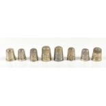 HENRY GRIFFITH & SONS LTD; eight hallmarked silver thimbles including a Llandudno souvenir