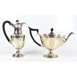 F JOHNSON & SONS; a George V hallmarked silver teapot of pedestal form with panelled detail,