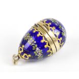 A 19th century Continental white and gilt metal vinaigrette in the form of an egg, with enamelled