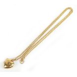 A 9ct yellow gold fine link chain supporting a 9ct heart shaped hinged pendant locket, length of