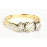 An 18ct yellow gold three stone illusion set diamond graduated ring, size M 1/2, approx 2.7g.