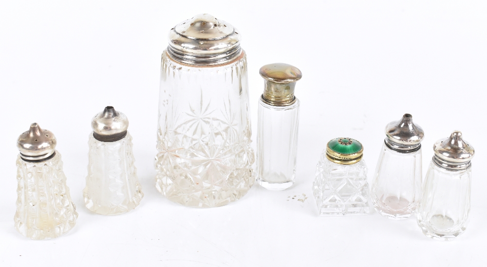 A group of silver topped clear glass sifters, peppers and vanity jars including guilloché