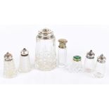 A group of silver topped clear glass sifters, peppers and vanity jars including guilloché