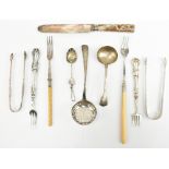 A George III hallmarked silver sifting spoon, marks rubbed, a pair of sugar tongs and a Tasmania