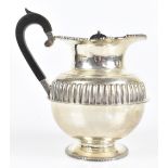 An Edward VII hallmarked silver footed water pot with gadrooned decoration to the central body, with