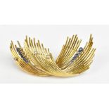 An 18ct yellow gold diamond and sapphire abstract brooch, length 5.8cm, approx 16.2g.Additional