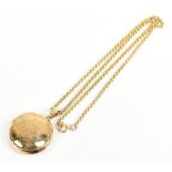 A 9ct yellow gold chain supporting a circular floral engraved locket, length of chain 40cm, combined