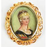 A yellow metal pendant centered with the oval portrait of a young woman and with 18ct yellow gold
