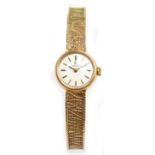 OMEGA; a 9ct yellow gold lady's wristwatch, the dial set with baton numerals, diameter excluding