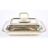 ATKIN BROS LTD; a George V hallmarked silver entrée dish and cover with cast edge and handle,