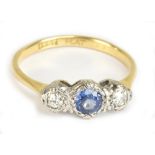 An 18ct yellow gold sapphire and diamond three stone ring, the central sapphire weighing approx 0.