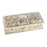 WILLIAM COMYNS; a late Victorian hallmarked silver trinket box, the embossed decoration featuring