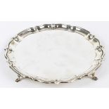 BARKER BROS; a George V hallmarked silver card tray of circular form with a cast pie crust edge,