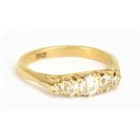An 18ct yellow gold five stone graduated diamond ring, the central stone weighing approx 0.15cts