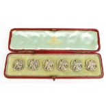 A cased set of Edwardian hallmarked silver Art Nouveau buttons, each decorated with the profile bust