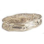 An Edwardian hallmarked silver Art Nouveau decorated trinket box of rounded lozenge form, embossed