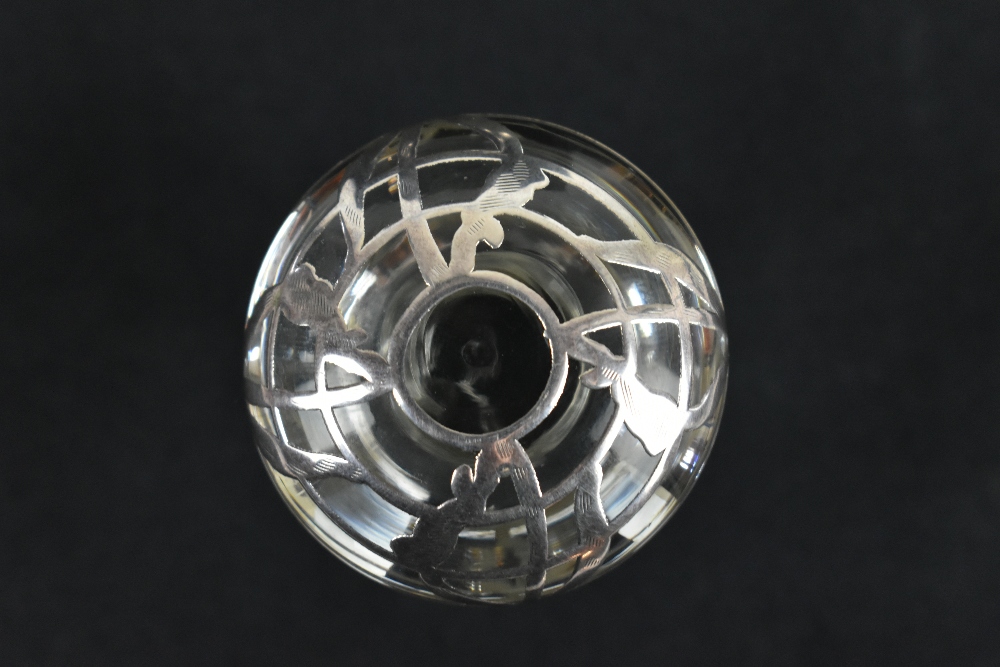 A pair of early/mid-20th century clear glass scent bottles and stoppers, with white metal overlay of - Image 2 of 3
