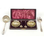A matched pair of hallmarked silver open salts with gilded interiors, in the form of open shells,