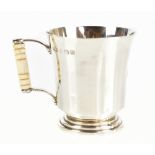 FINNIGANS LTD; a hallmarked silver mug on stepped pedestal base with ivory handle, with engraved