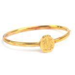 An unusual Victorian 18ct yellow gold memoriam hinged snap bangle with raised locket section