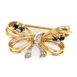 A 9ct yellow gold sapphire and diamond brooch in the form of a ribbon tied bow, length 2.7cm, approx