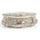 WALKER & HALL; an Edward VII hallmarked silver oval shaped box and cover, with repoussé floral