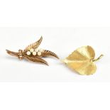 A 9ct yellow gold fern leaf and pearl brooch, also a leaf brooch, combined approx 7.1g.Additional