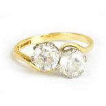 An 18ct yellow gold two stone crossover ring, size L 1/2, approx 3.2g.Additional InformationThe