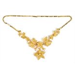 An Edwardian 15ct yellow gold and seed pearl floral necklace, the pendant drop with brooch back,