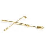 A 9ct yellow gold stick/pin brooch in the form of a pair of crossed gold clubs, length 7cm, approx