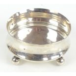 A George V hallmarked silver Art Deco designed circular bowl with wasted sides and raised on four