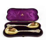 HJ LIAS & SON; a pair of Victorian hallmarked silver gilt spoons, each with gilt bowls and cast