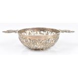 WILLIAM COMYNS; a late Victorian hallmarked silver pierced quaich, with scroll decoration to the