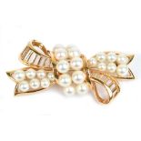 MIKIMOTO; a 14ct yellow gold and cultured pear ribbon tie bar brooch, length 5.5cm, approx 14g.