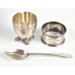 A hallmarked silver matched three piece christening set comprising egg cup by Adie Bros,