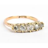 An 18ct yellow gold five stone diamond ring, the central diamond weighing approx 0.20ct in scroll