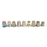JAMES SWANN & SON; a group of nine hallmarked silver thimbles including three glass topped