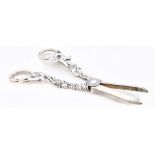 ISRAELI FREEMAN & SON; a pair of Elizabeth II hallmarked silver grape scissors with cast handles,