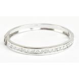 A good 18ct white gold and diamond hinged bangle, the nineteen round brilliant cut stones channel