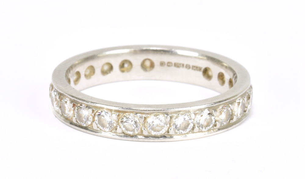 WITHDRAWN A platinum and diamond full eternity ring set with round brilliant cut stones, size K,