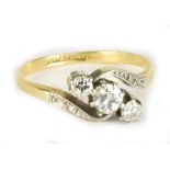 An 18ct yellow gold platinum set three stone diamond ring, the central diamond weighing approx 0.