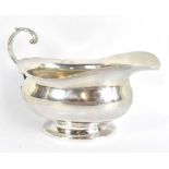 A George VI hallmarked silver sauce boat, with oval foot and simple loop handle, Birmingham 1939,