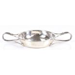 ALBERT EDWARD JONES; a George V hallmarked silver Arts & Crafts twin handled bowl with planished