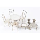 A matched pair of miniature Elizabeth II hallmarked silver models of chairs, one with cat upon the